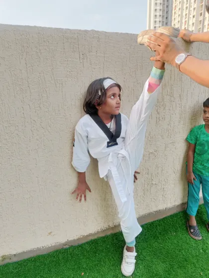 Flexibility is just as important as strength in Taekwondo. This kind of dedicated stretching, demonstrated by one of my young students, is key to preventing injury and executing powerful, high kicks.