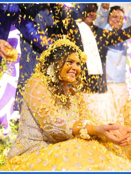 A close-up of the bride's happy face as she is showered with flowers. This is the essence of a Phoolon ki Holi.
