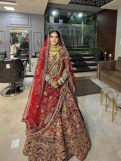 A full view of the bride in our salon, ready for her wedding. The entire look, from the makeup to the hair and the draping of her saree, is done with utmost care.