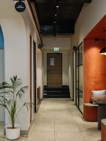 The corridor design uses arches and contrasting colors to create visual interest and define different zones.