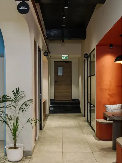 The corridor design uses arches and contrasting colors to create visual interest and define different zones.