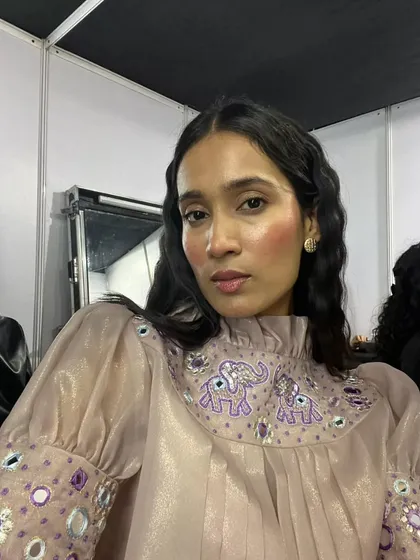 The complete look, showing how the draped blush and dewy skin complement the embroidered top. It's a perfect balance of modern makeup and traditional design elements.