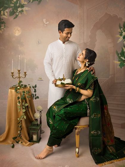 A loving couple's portrait from a traditional maternity session. The husband-to-be gently places his hand on his wife's shoulder as she holds a platter, symbolizing their shared journey.