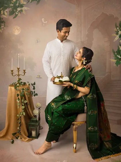 A sweet moment between the couple in a traditional setting. The husband gazes lovingly at his wife as she sits, holding a tray of jasmine flowers, embodying grace and beauty.