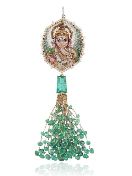 This Lord Ganesha pendant is a piece I hold very dear. The micromosaic portrait is set in 18k gold with a tassel of Zambian emeralds from Gemfields. On the back, I have etched the Vakratunda Mahakaya shloka to banish obstacles and welcome new beginnings.