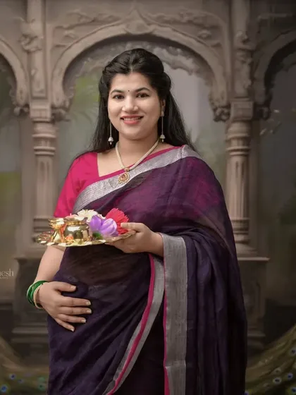 Here is another take on the traditional theme, set against a backdrop inspired by royal Indian architecture. The rich colors of her saree stand out beautifully.