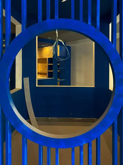 A perspective shot through the circular entryway during the construction phase. This element was designed to act as a visual portal, drawing customers deeper into the brand experience center.