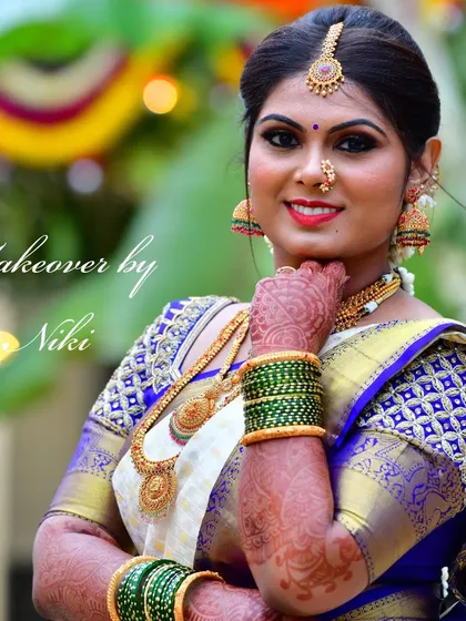 My beautiful bride Namrata, glowing for her wedding. Her look features bold, defined eyes and a bright smile, perfect for her white and blue silk saree.