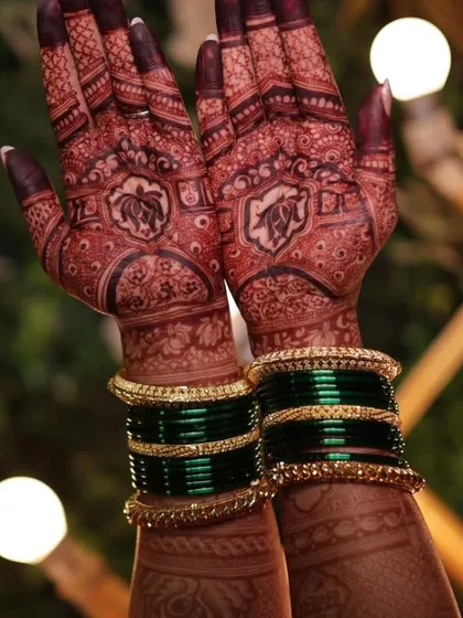 The result of my natural henna is a deep, rich stain. This photo shows the beautiful dark color after the paste has been removed, complemented by traditional green bangles.