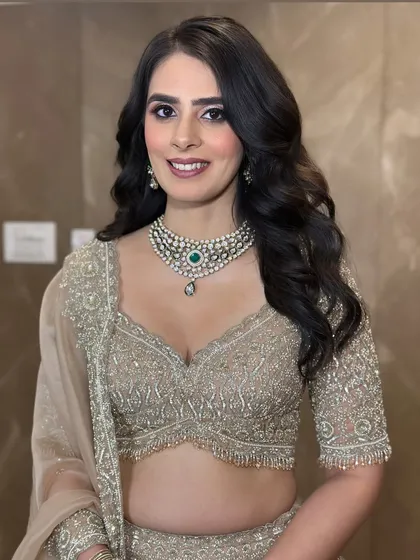 A beautiful, smiling portrait of the engagement bride. The subtle glam makeup enhances her features perfectly, and the soft curls frame her face beautifully.