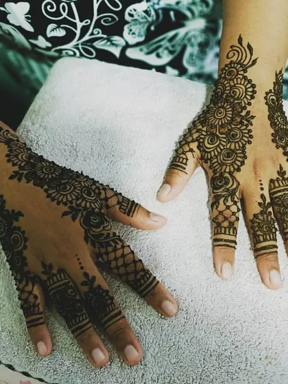 This is my signature bridal mehendi style, featuring symmetrical floral patterns that create a full, elegant look. I design the henna to flow beautifully across both hands, ensuring it looks perfect from every angle on your special day.