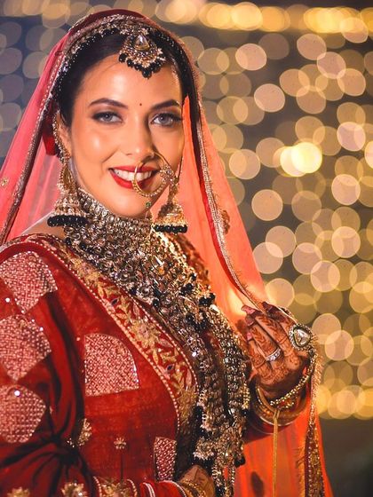 A beautiful portrait of Shraddha against a bokeh background, highlighting her radiant smile and flawless makeup.