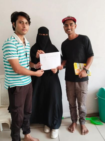 Participants of the "Be a Jagrik" program proudly hold up their work. These sessions empower them to tackle complex topics like gender, religion, and dowry through creative expression.