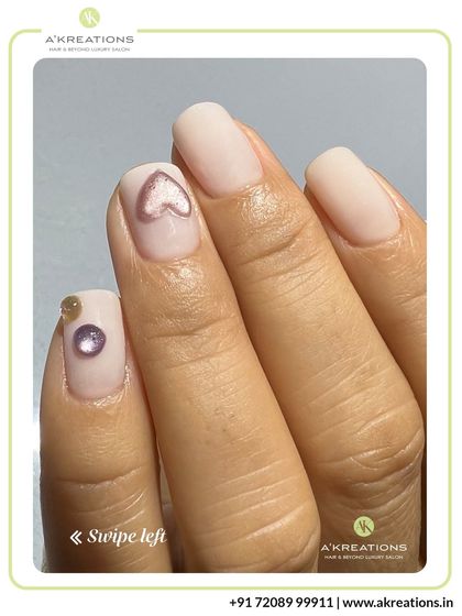 A detailed close-up of the 3D heart and gem accents, highlighting the precision of the application on a clean, matte white nail base.