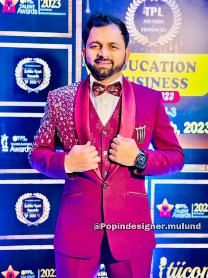 This client is ready for the red carpet in a stunning magenta three-piece suit with an embellished shoulder detail. It's a true showstopper for any awards night or grand celebration.