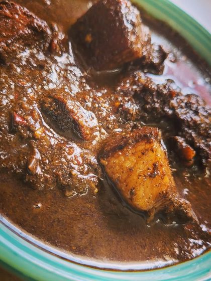 A close up shot of the Anishi with Pork. The texture of the gravy is thick and luscious, clinging to every piece of pork. This is a must-try for adventurous food lovers.