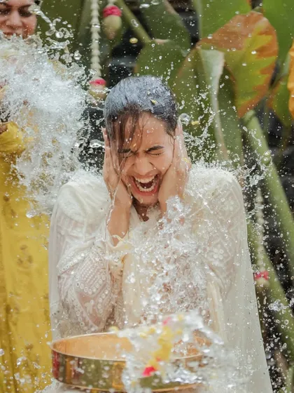 The exhilarating moment of being doused with water during a Pellikuthuru ceremony. We freeze these split-second expressions of shock and pure joy.