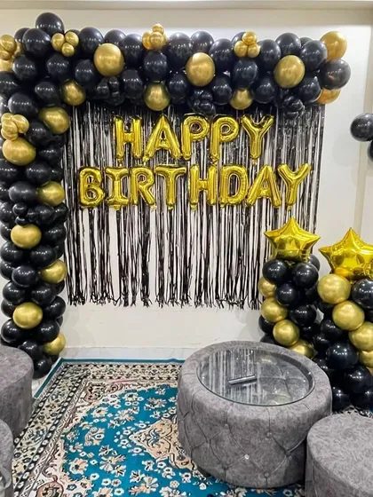 A wider view of the black and gold setup, showing how it can transform a living room space.