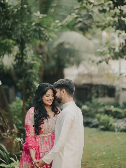 A romantic shot of the engaged couple. The bride's makeup is soft and pretty, with loose curls adding to the romantic feel.