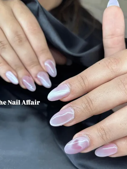 A soft, ethereal manicure with a pink and white marbled effect and a pearlescent chrome overlay.