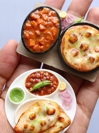 A pair of naan and channa miniatures, one on a plate and one on a wooden board.