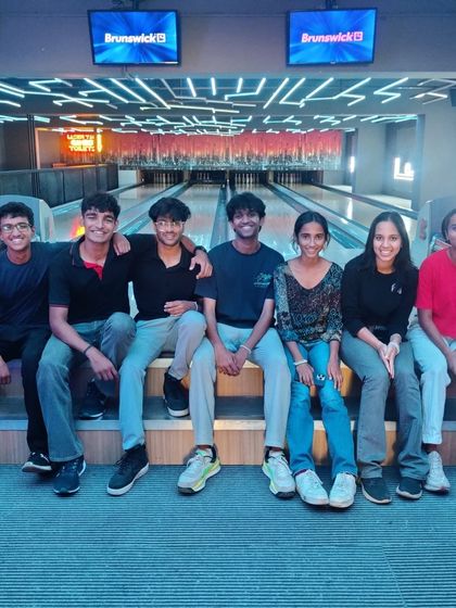 A group of young friends sitting together at our bowling alley.