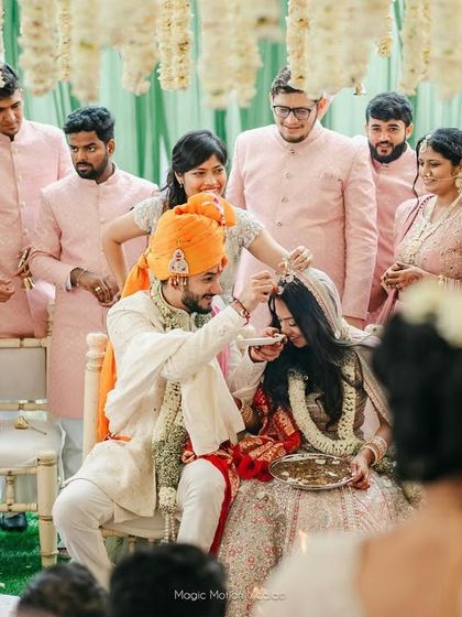 A wedding is about two families coming together. This photo captures a sweet ritual between the bride and groom, surrounded by their loved ones.