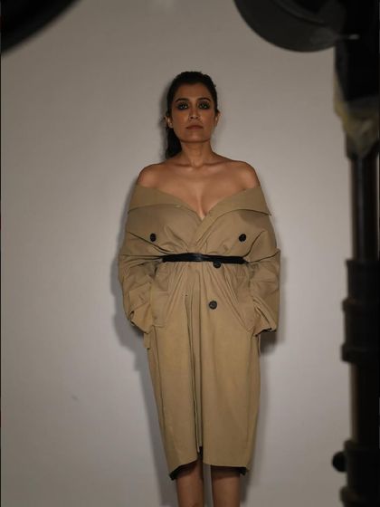 A full-length shot of the stylish trench coat look from a birthday shoot, showing the entire powerful silhouette.