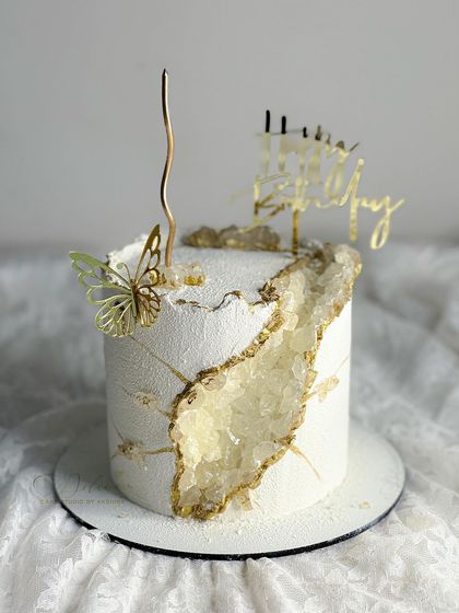 Another angle of our white velvet geode cake, showing the intricate crystal details and the elegant gold butterfly accent.