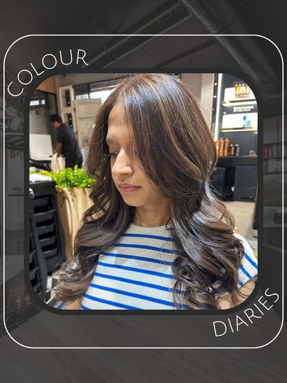 A side view of the "Colour Diaries" look, showing the seamless color and the expertly styled layers that create a full, healthy appearance.