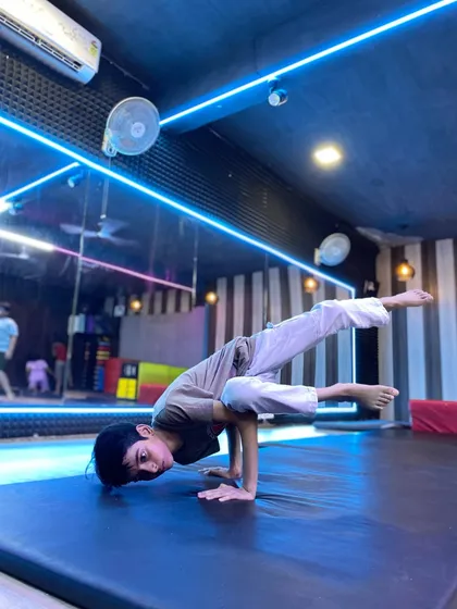 Strength and control are fundamental to our training. This student demonstrates an advanced hand balance, a skill developed through our specialized gymnastics for dancers program.