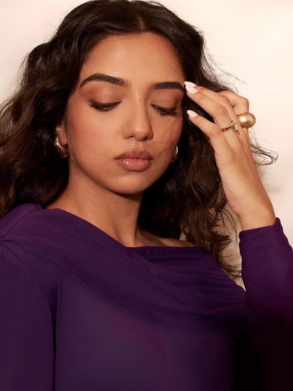 This shot focuses on the details, from the manicure to the gold rings, which complete Ahsaas Channa's elegant look for the Elle editorial.