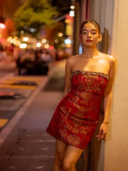 A chic after party look for Anushka Sen at the Cannes Film Festival. This strapless red mini dress is made from a beautiful Banarasi fabric, blending Indian textile traditions with a contemporary silhouette.