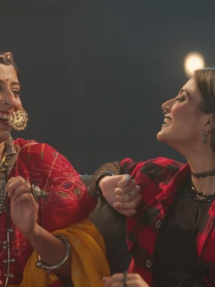 A punk-rock fan and a woman in traditional Rajasthani attire find a connection. I used contrasting styles, like a plaid shirt and silver jewelry, to highlight their different backgrounds.