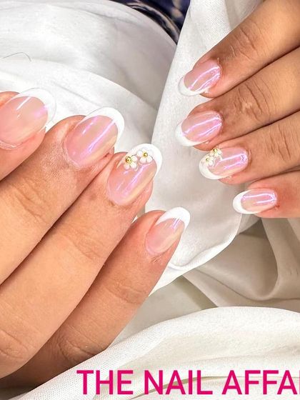 An elegant French manicure with a twist. I added a small, hand-crafted 3D flower made of tiny pearls on the accent nail for a delicate and unique detail.