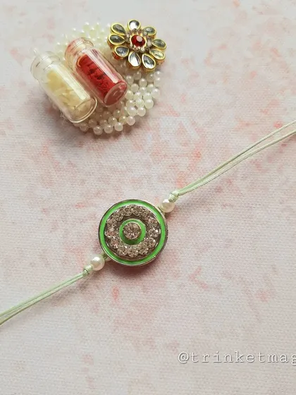 A closer look at the green crystal Rakhi. It comes with a beautiful Kundan-style Roli-Chawal holder, making it a complete set for the Rakhi ceremony.