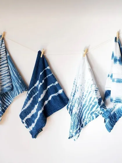 Here are some examples of my custom indigo dyeing work, showcasing different Shibori tie-dye techniques. Each piece is handcrafted on natural fabric, resulting in unique patterns ranging from deep ocean blues to crisp whites. These are perfect for sustainable fashion collections.
