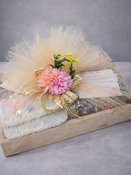A baby girl's birthday calls for a gift that is as beautiful as it is thoughtful. This curated birthday hamper in a wooden tray includes an aroma diffuser, assorted chocolate truffles, cookies, and cute accessories. The soft colors and premium treats make it a perfect gift for new parents and baby showers.