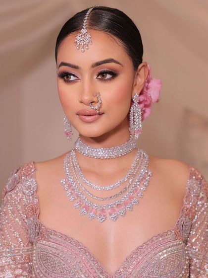 A beautiful portrait of the bride, her diamond jewelry and soft makeup creating a look of modern elegance.