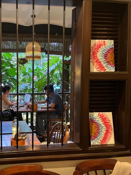 The finished couple's art pieces, seen from outside the cafe window. They add a touch of beauty to the space.