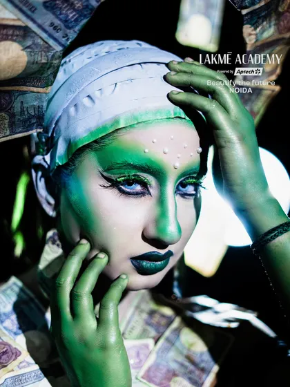 A detailed close-up of the "money goddess" fantasy makeup. The sharp graphic liner and green contouring showcase the precise techniques required for such creative looks.