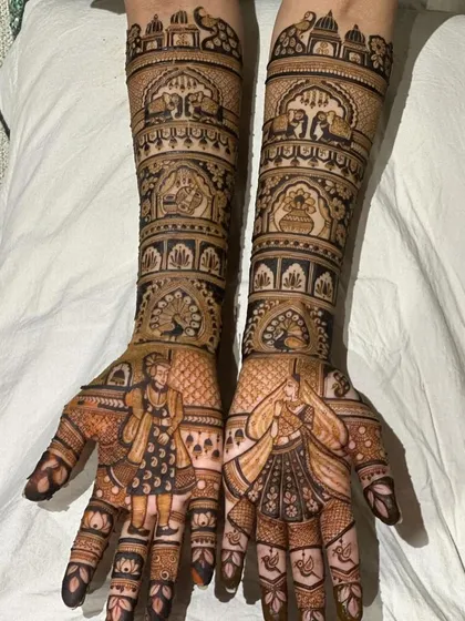 A classic bridal design with portraits of the couple on the palms and traditional motifs on the arms.