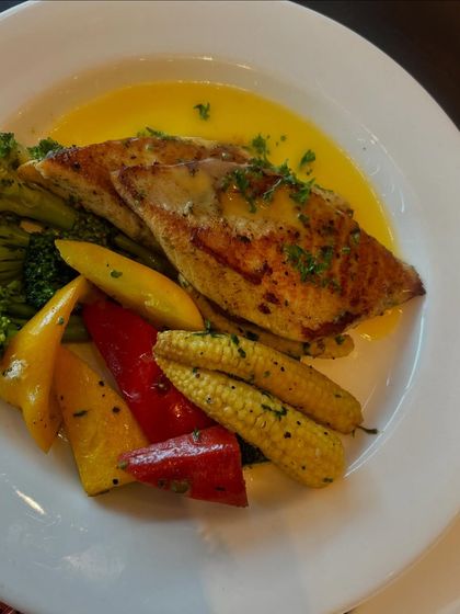 Highlighting a specific dish: the grilled fish with vegetables. My food content focuses on making each dish look fresh, delicious, and expertly prepared.