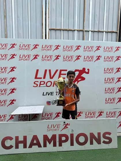 A proud player from our U13 team with the championship trophy.