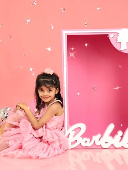 Sitting pretty next to her Barbie box, surrounded by disco balls. This setup is perfect for a girl who loves to sparkle.