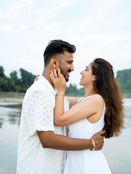 A tender and romantic pre-wedding portrait on the beach, capturing a look of deep affection.