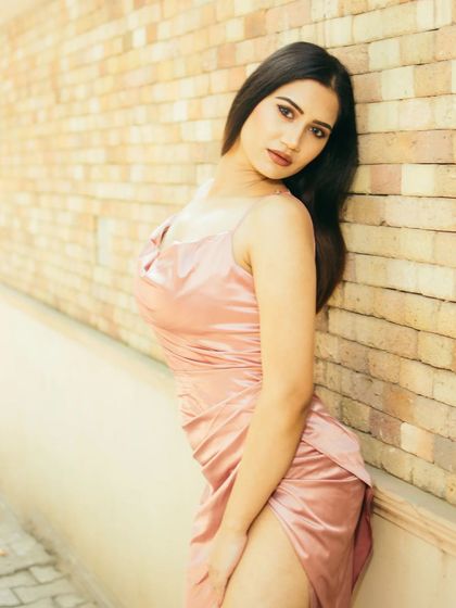 Another angle from the brick wall series, this time with a direct look to the camera. It shows the versatility of a single location for capturing different moods, from pensive to engaging.