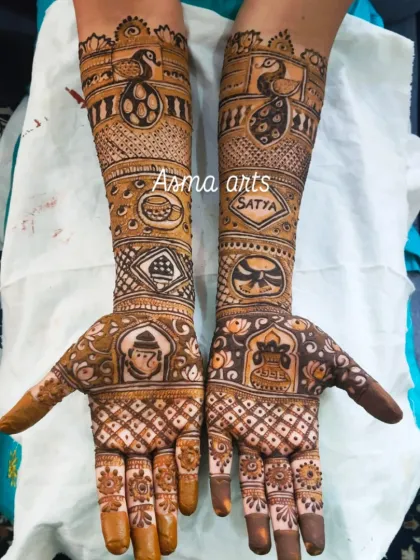 A personalized bridal design incorporating a Ganesha for blessings, the couple's name 'Satya', and other meaningful symbols chosen by the bride.