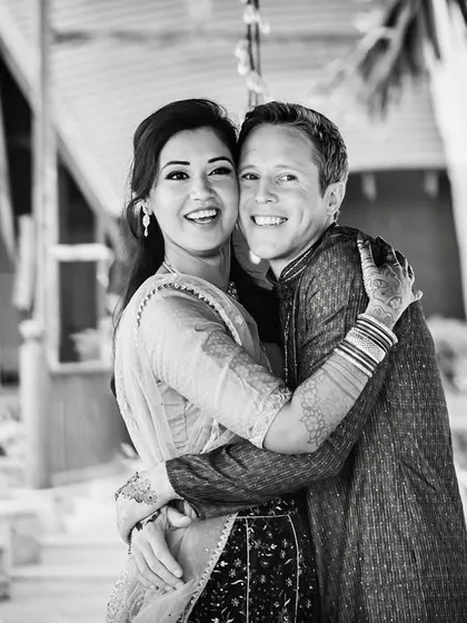 A joyful black and white portrait that captures a beautiful, genuine hug. The monochrome format enhances the emotional impact and the happiness radiating from the couple.