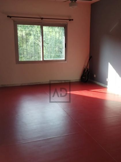 A wider view of the room, showing how the bright red floor becomes the main feature. This type of flooring is also great for a home gym or a kids' activity room.